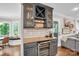 Charming dining area with a built-in bar, wine cooler, and decorative backsplash at 9809 Hanover Hollow Dr, Charlotte, NC 28210