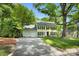 Traditional two-story home with yellow siding, black shutters, and a well-manicured front lawn at 9809 Hanover Hollow Dr, Charlotte, NC 28210