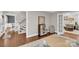 Open foyer with hardwood floors, staircase, and access to the living areas at 9809 Hanover Hollow Dr, Charlotte, NC 28210