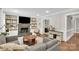Spacious living room with a fireplace, built-in shelving, and hardwood floors at 9809 Hanover Hollow Dr, Charlotte, NC 28210