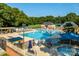 A large community pool area with a lap pool, pool, lounge chairs, and landscaped surroundings at 9809 Hanover Hollow Dr, Charlotte, NC 28210