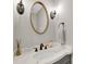 Elegant powder room with marble countertop vanity, designer mirror, and sconce lighting at 9809 Hanover Hollow Dr, Charlotte, NC 28210