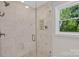 Walk-in shower with elegant tile, glass door and a refreshing view to the outdoors at 9809 Hanover Hollow Dr, Charlotte, NC 28210