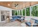 Bright sunroom with vaulted wood ceiling, large windows, and cozy seating at 9809 Hanover Hollow Dr, Charlotte, NC 28210