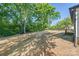 Expansive backyard with freshly laid straw, mature trees, and the house in the background at 1 Linestowe Dr, Belmont, NC 28012