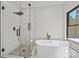 Bathroom showcasing a modern shower with glass door and elegant tub with matte black hardware at 1 Linestowe Dr, Belmont, NC 28012