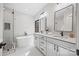 Elegant bathroom featuring double sinks, sleek mirrors, a freestanding tub, and a tiled shower at 1 Linestowe Dr, Belmont, NC 28012