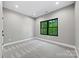 A bright bedroom featuring soft carpet, a modern window with green outdoor views, and recessed lighting at 1 Linestowe Dr, Belmont, NC 28012