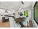 A dining room features a wood table, plush chairs, and decorative pendant lights, open to a modern kitchen at 1 Linestowe Dr, Belmont, NC 28012