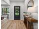 Bright entryway with wood floors, console table with decor, and a decorative mirror at 1 Linestowe Dr, Belmont, NC 28012