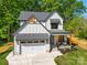 Striking view of a two-story home featuring a garage and a charming front porch at 1 Linestowe Dr, Belmont, NC 28012