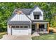 Charming two-story home with white siding, black trim, attached garage and covered front porch at 1 Linestowe Dr, Belmont, NC 28012