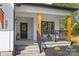 Inviting front porch with black metal railing, wood columns, and seating area at 1 Linestowe Dr, Belmont, NC 28012