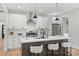 Bright kitchen with white cabinets, stainless steel appliances, a subway tile backsplash, and a center island at 1 Linestowe Dr, Belmont, NC 28012