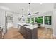 Open concept kitchen with a large island, stainless steel appliances, and dining area with natural light at 1 Linestowe Dr, Belmont, NC 28012