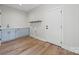 Laundry room featuring light blue cabinets, a sink, and wood flooring at 1 Linestowe Dr, Belmont, NC 28012