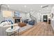 Open-concept living room featuring a fireplace, staircase, and stylish furnishings at 1 Linestowe Dr, Belmont, NC 28012