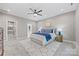 Stylishly designed primary bedroom with a ceiling fan, patterned rug, and ensuite bathroom access at 1 Linestowe Dr, Belmont, NC 28012