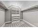 Walk-in closet with bright white shelving and drawer organizers for optimal storage at 1 Linestowe Dr, Belmont, NC 28012