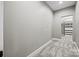 Spacious walk-in closet area with neutral walls and access to the ensuite bathroom at 1 Linestowe Dr, Belmont, NC 28012