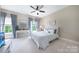 Bright bedroom with blue accents, a ceiling fan, and large windows offering ample natural light at 101 Stonehurst Ln, Waxhaw, NC 28173