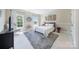 Comfortable bedroom featuring a gray upholstered bed, large windows, and stylish decor at 101 Stonehurst Ln, Waxhaw, NC 28173