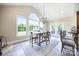 Sunlit breakfast nook featuring large windows and elegant chandelier lighting, perfect for morning meals at 101 Stonehurst Ln, Waxhaw, NC 28173