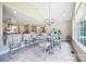 Bright breakfast nook with an open view to the kitchen area, featuring a chandelier and large windows at 101 Stonehurst Ln, Waxhaw, NC 28173