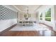 Bright dining room featuring a modern chandelier, large windows, and stylish decor at 101 Stonehurst Ln, Waxhaw, NC 28173