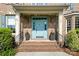 Charming front entrance with a blue door, brick steps, and manicured landscaping at 101 Stonehurst Ln, Waxhaw, NC 28173