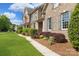 Landscaped front yard and brick facade of a beautiful home with manicured shrubs at 101 Stonehurst Ln, Waxhaw, NC 28173