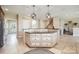 Spacious kitchen island with countertop and drawers, and stainless steel refrigerator at 101 Stonehurst Ln, Waxhaw, NC 28173