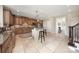 Large kitchen with tiled floors, central island, stainless appliances and adjacent hallway at 101 Stonehurst Ln, Waxhaw, NC 28173
