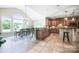 Elegant kitchen and dining area with tile floors, stainless steel appliances and large windows at 101 Stonehurst Ln, Waxhaw, NC 28173