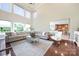 Inviting living room with large windows, hardwood floors, and view of kitchen at 101 Stonehurst Ln, Waxhaw, NC 28173