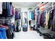 Spacious walk-in closet with custom shelving, hanging rods, and a mirror to maximize storage and organization at 101 Stonehurst Ln, Waxhaw, NC 28173