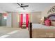 Bright bedroom with plush carpet, stylish decor, and lots of natural light through the windows at 10116 Garman Hill Dr, Charlotte, NC 28214