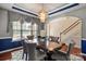 Dining room featuring an elegant chandelier, large window, and a spacious table set for delightful gatherings at 10116 Garman Hill Dr, Charlotte, NC 28214
