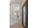 Hallway view leading to a full bathroom with tile floors and a shower at 10116 Garman Hill Dr, Charlotte, NC 28214