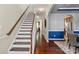 Elegant staircase leading to the upper level with hardwood floors and sophisticated color palette at 10116 Garman Hill Dr, Charlotte, NC 28214