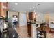 Well-lit kitchen featuring dark granite countertops, a breakfast bar, and modern appliances at 10116 Garman Hill Dr, Charlotte, NC 28214
