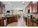 Updated kitchen showcasing dark granite countertops, stainless appliances, and tile backsplash at 10116 Garman Hill Dr, Charlotte, NC 28214