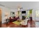 Comfortable living room with hardwood floors, ceiling fan, fireplace, and a sliding glass door leading to the backyard at 10116 Garman Hill Dr, Charlotte, NC 28214