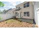 Spacious backyard featuring a small patio, AC unit, and mature landscaping at 11011 Alderbrook Ln, Charlotte, NC 28270