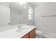 Well-lit bathroom featuring vanity with sink, large mirror, and neutral walls at 11011 Alderbrook Ln, Charlotte, NC 28270