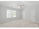 A spacious bedroom with a ceiling fan, plush carpet and lots of natural light at 11011 Alderbrook Ln, Charlotte, NC 28270