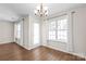 Bright dining area featuring hardwood floors, elegant chandelier, and windows with natural light at 11011 Alderbrook Ln, Charlotte, NC 28270