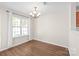 Bright dining room with hardwood floors, chandelier, and large window at 11011 Alderbrook Ln, Charlotte, NC 28270