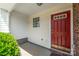 Welcoming front porch with a vibrant red door and well-maintained exterior at 11011 Alderbrook Ln, Charlotte, NC 28270