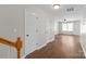 Inviting hallway featuring hardwood floors, white trim, and multiple doors at 11011 Alderbrook Ln, Charlotte, NC 28270